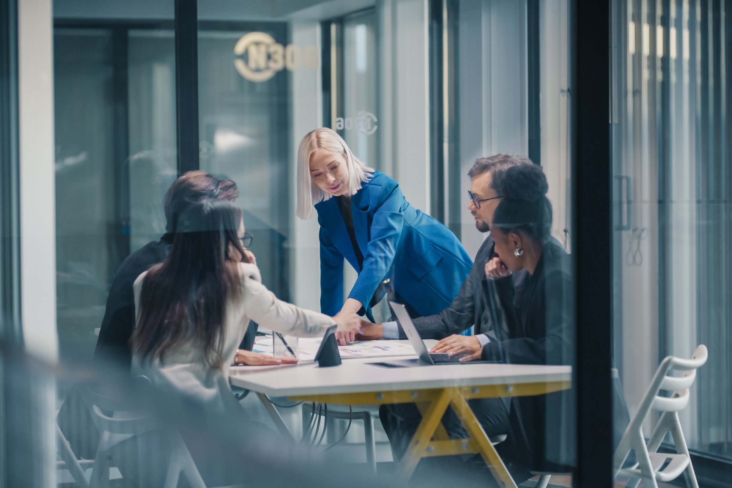 Women pointing to documents on table in corporate meeting